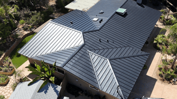 Standing seam metal roof on a residential home, ideal for solar panel installation due to its durability and compatibility with solar mounting systems.