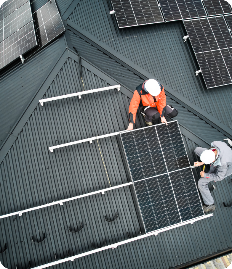 Worker installing solar panel.